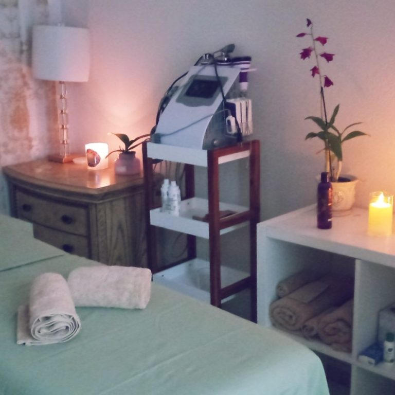 Serene Environment Peaceful spa setting with soft lighting, candles, and towels, designed to promote relaxation