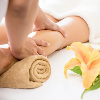 Expert Therapists Certified massage therapist providing a relaxing arm massage with a flower in the background